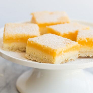 lemon cheesecake bars on white plate