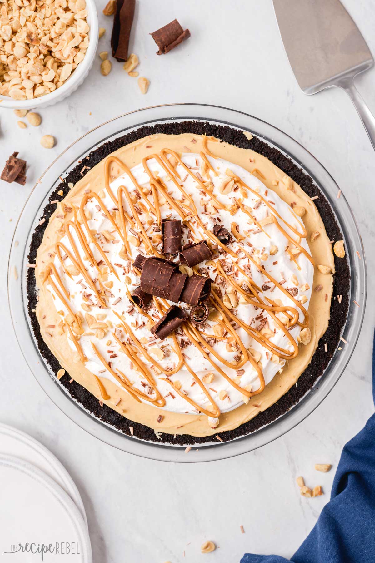 finished peanut butter pie with whipped cream peanut butter drizzle and chocolate shavings