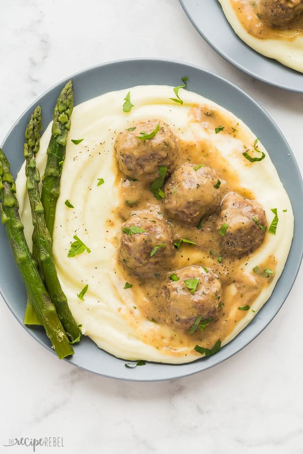 easy swedish meatballs overhead on grey plate with mashed potatoes and asparagus
