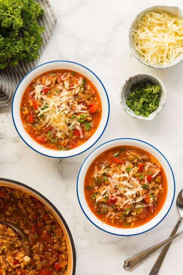 stuffed pepper soup in white bowls with blue rim overhead