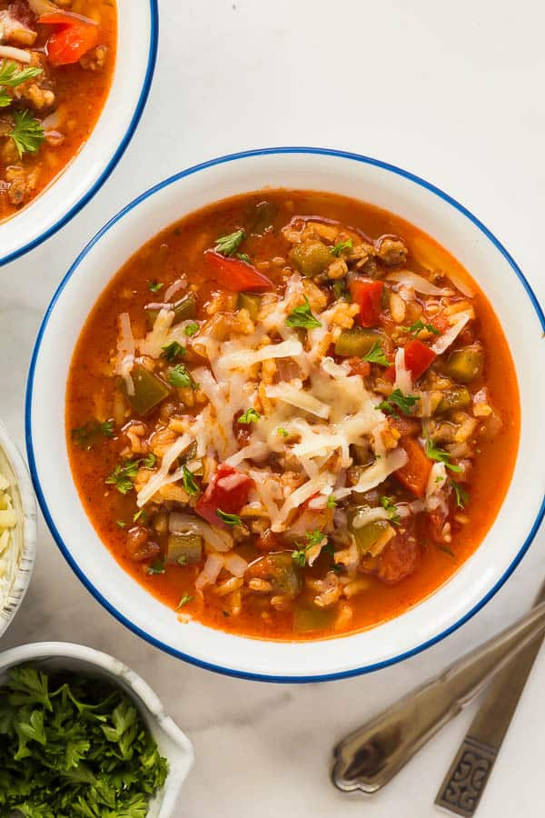 stuffed pepper soup close up overhead with shredded cheese and parsley garnish