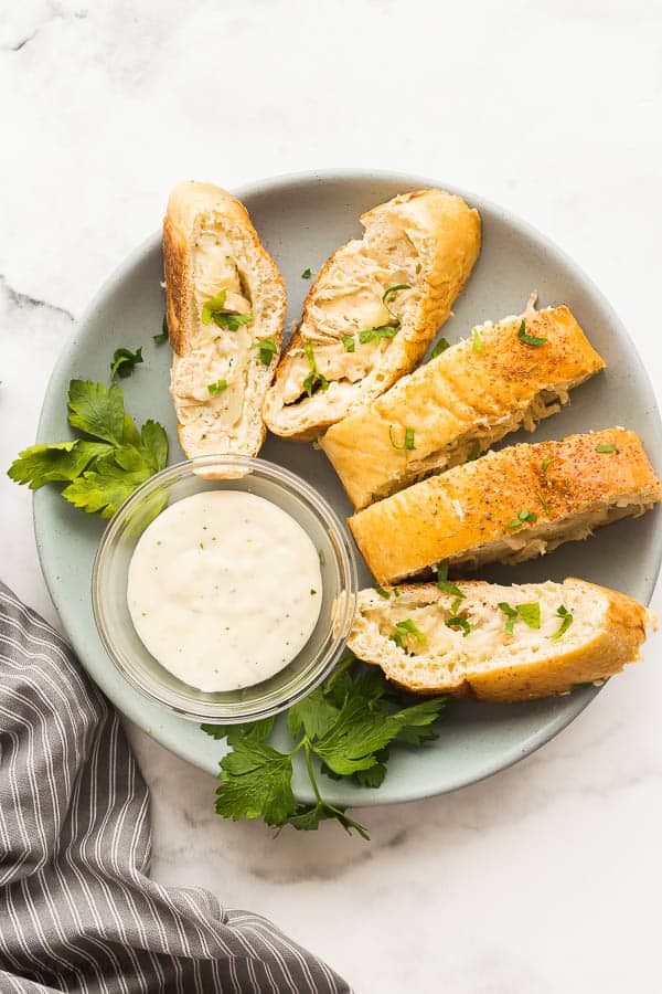 sliced stromboli overhead on grey plate with grey striped towel