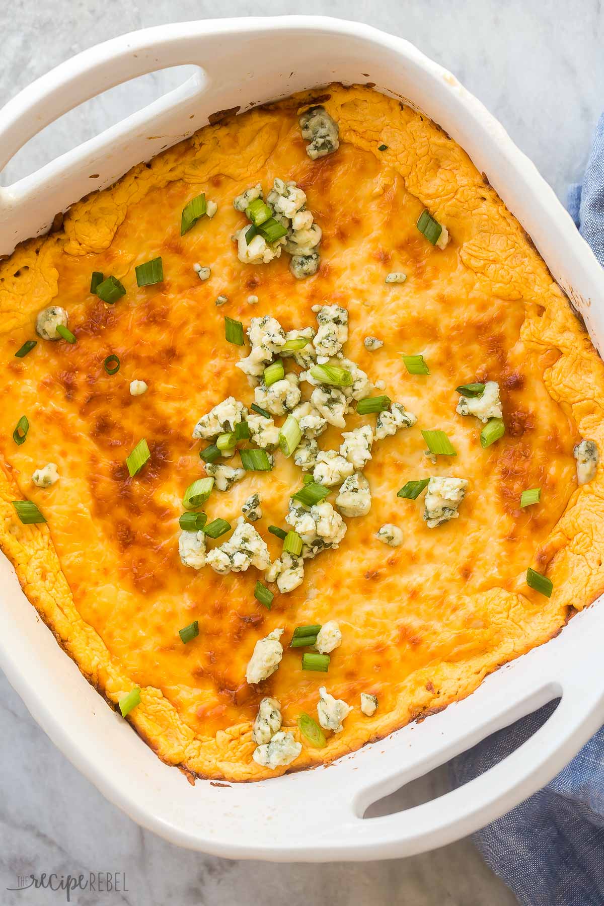 close up image of buffalo chicken dip with blue cheese on top