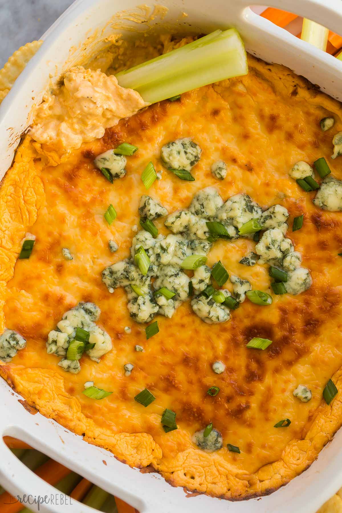 close up image of piece of celery scooping some buffalo chicken dip