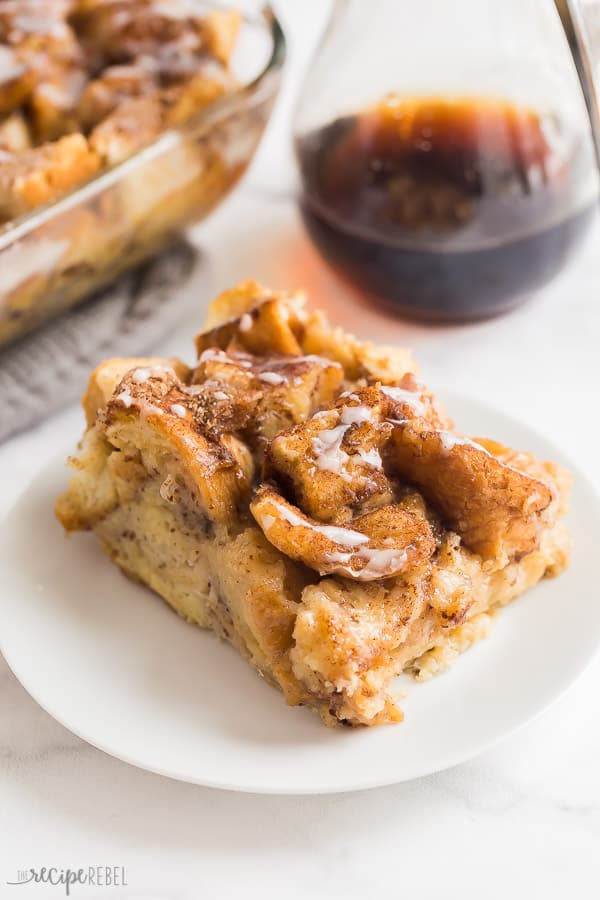 french toast casserole piece with pan and maple syrup in the background
