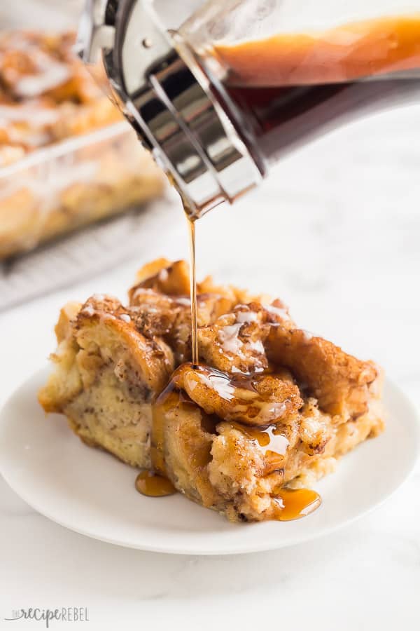 french toast casserole with syrup drizzle on white plate