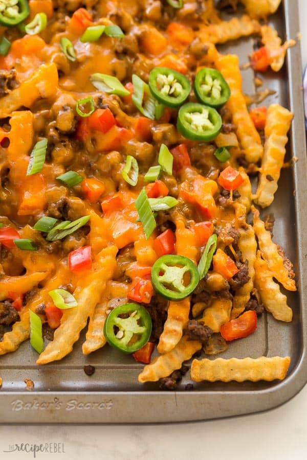 nacho fries overhead close up on grey baking pan on white background