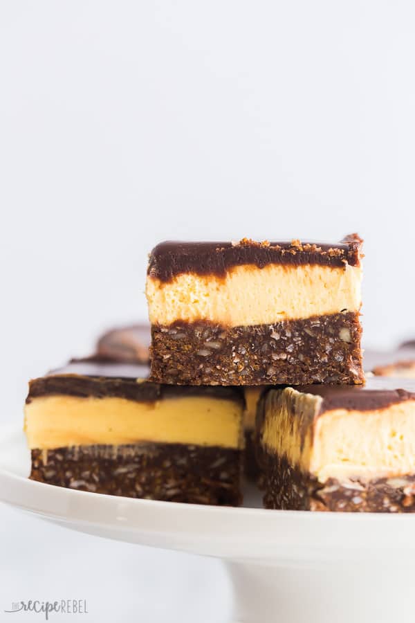 nanaimo bars close up pieces stacked on white plate