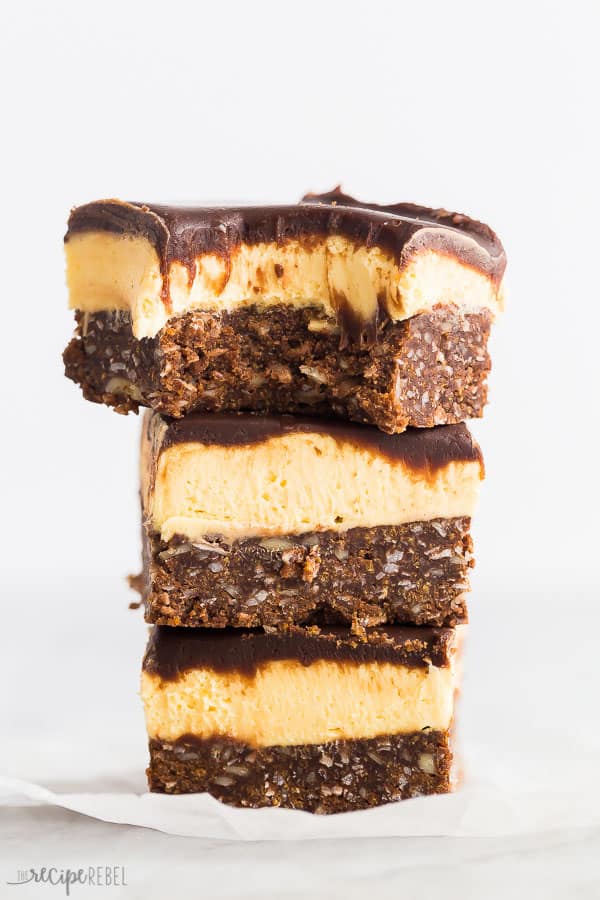 nanaimo bars stack of 3 with one bite taken out of the top bar