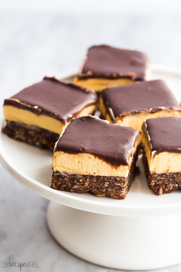 nanaimo bars on white plate on marble background