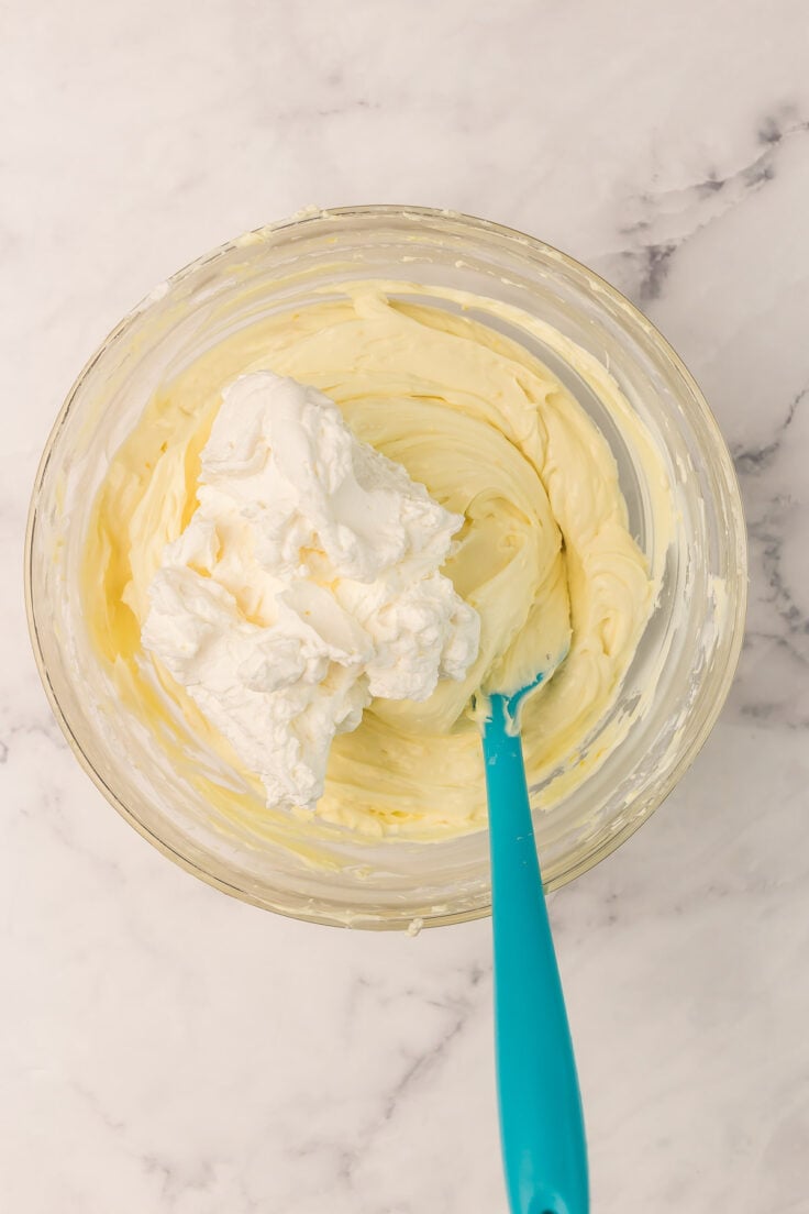 whipped cream going into lemon cream cheese mixture