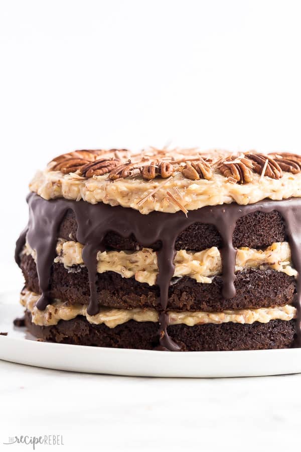 This German Chocolate Cake is made with rich, chocolate cake layers, coconut pecan frosting and chocolate frosting for an impressive cake that will wow your chocolate lovers! #cake #recipe #dessert #chocolate german chocolate cake whole with pecan frosting and chocolate ganache