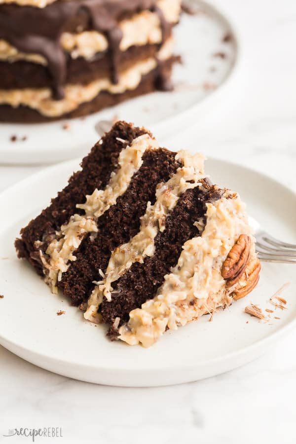 slice of german chocolate cake on white plate on white background