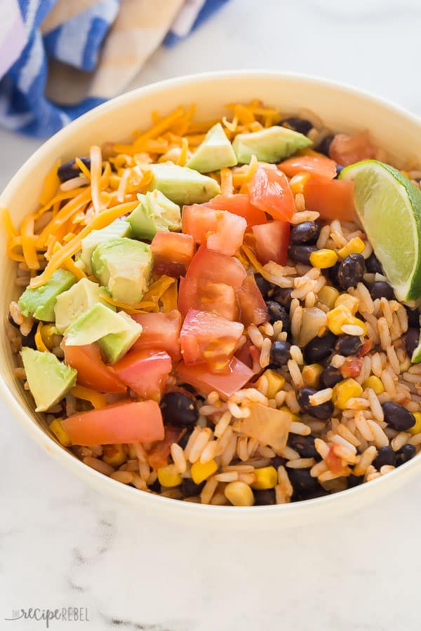 vegetarian burrito bowl with fresh tomatoes, avocado and shredded cheese