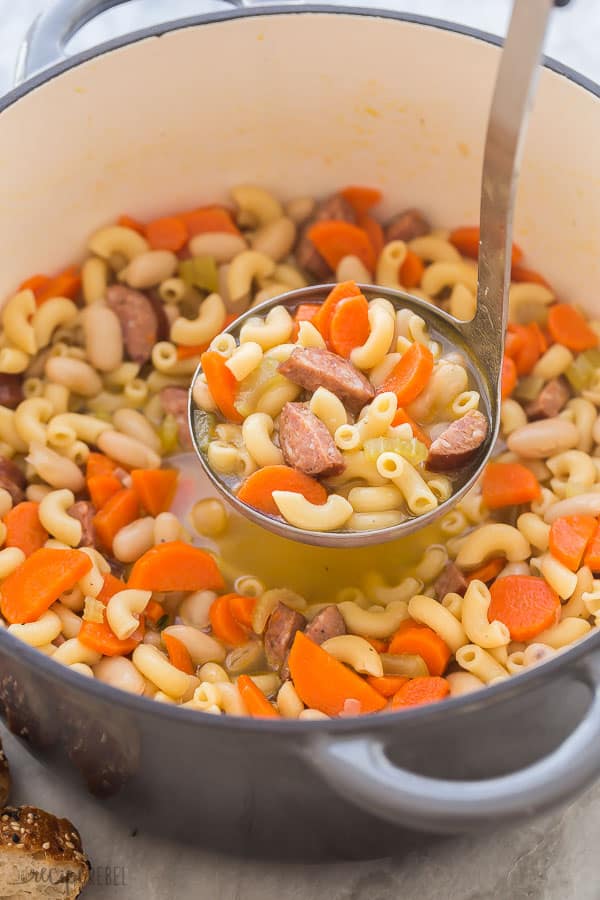 sausage minestrone in pot with scoop being pulled out