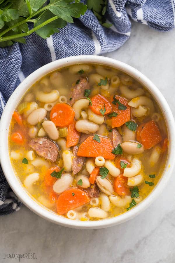 white minestrone with sausage in a bowl overhead close up