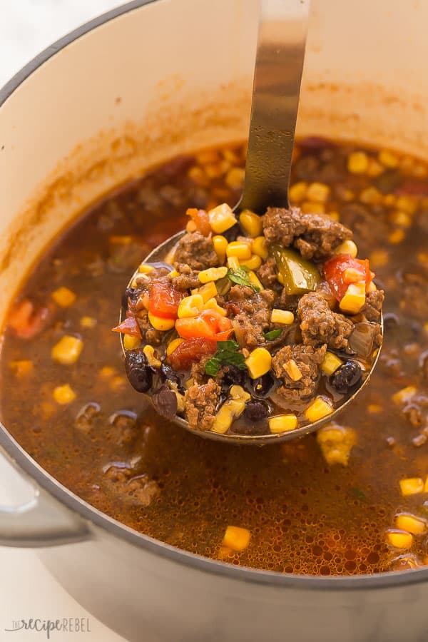 taco soup in pot with scoop being pulled out