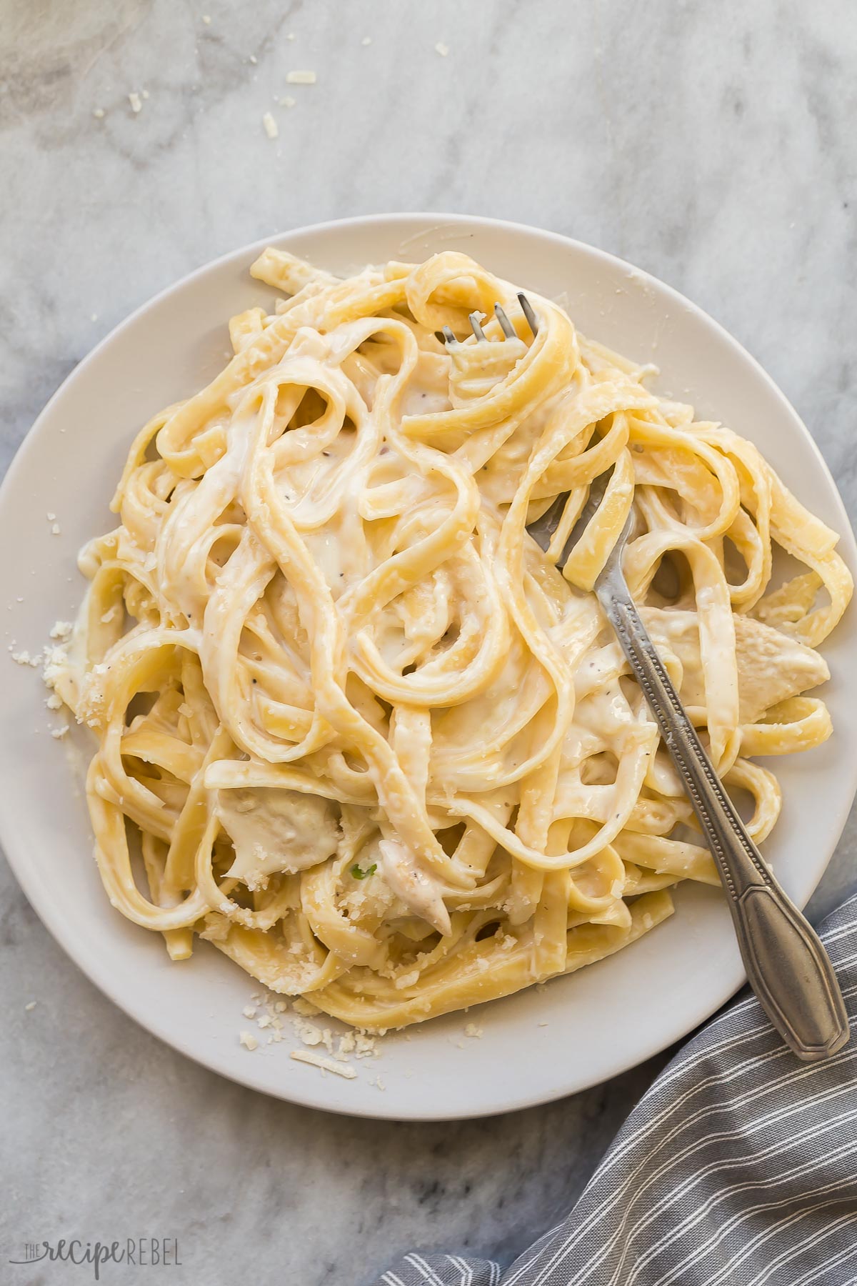 overhead image of plate of chicken fettuccine alfredo with fork
