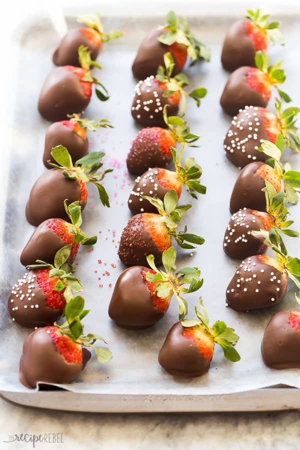 chocolate covered strawberries on pan with parchment paper in rows