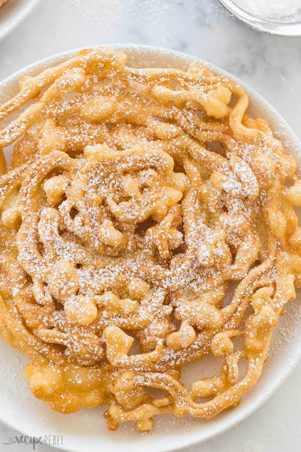funnel cake recipe overhead with powdered sugar on white plate
