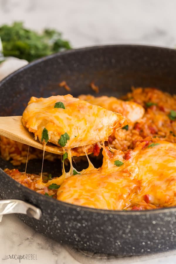 mango salsa chicken and rice being scooped out of pan