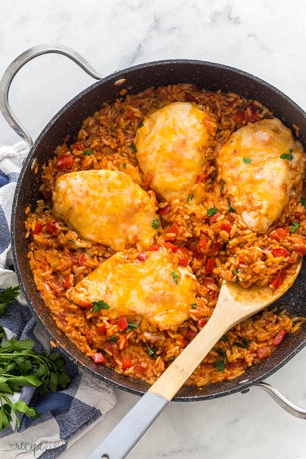 mango salsa chicken and rice overhead in large black pan on white background