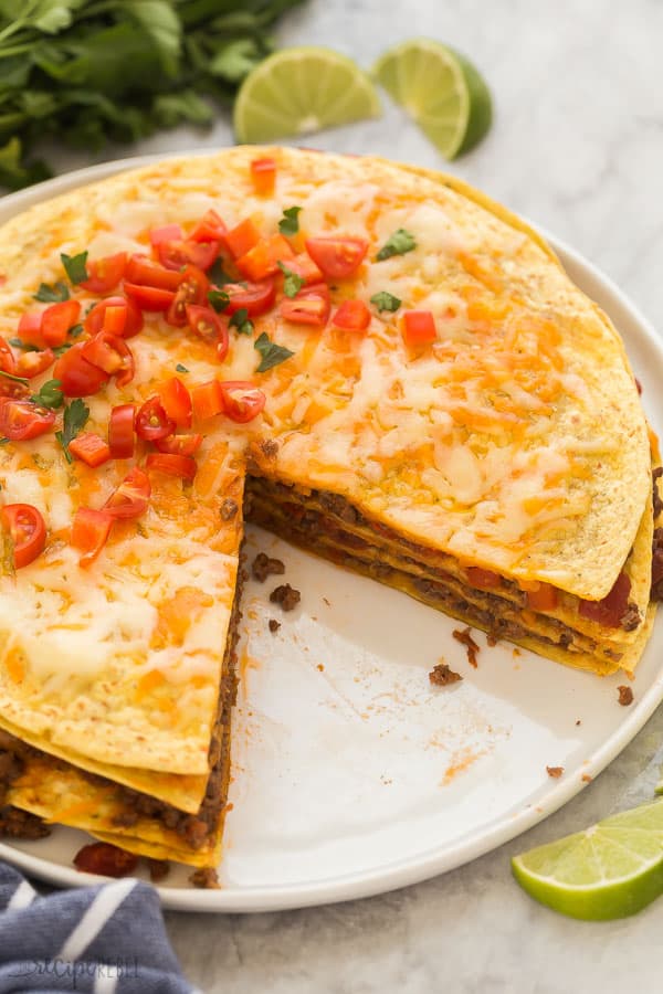 taco casserole on white plate with one slice missing