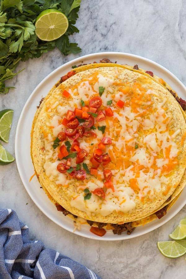 taco casserole whole overhead with cheese and chopped tomatoes