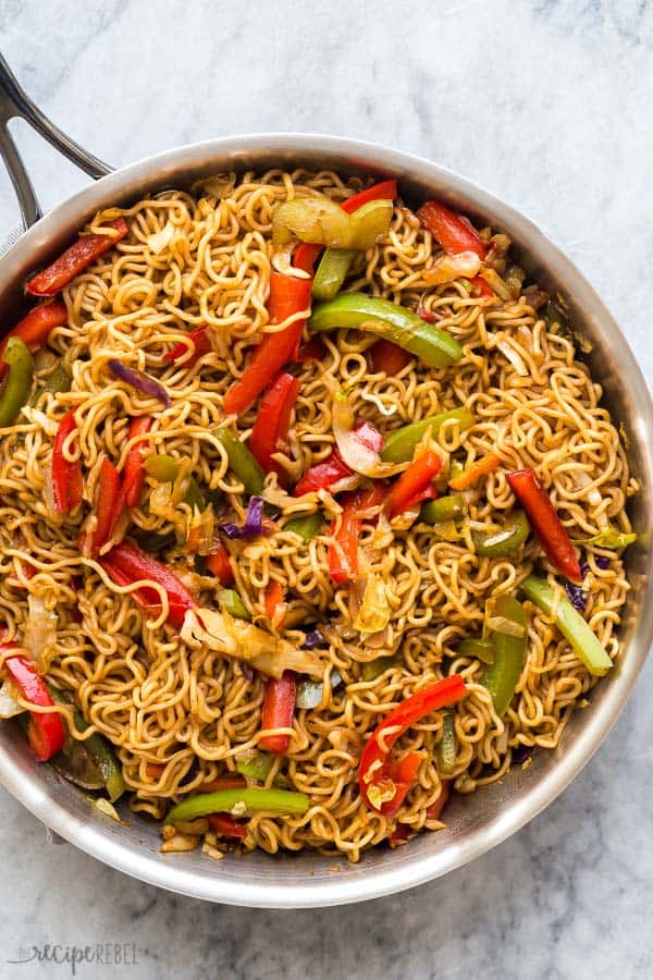 vegetable lo mein in stainless steel pan on grey marble background