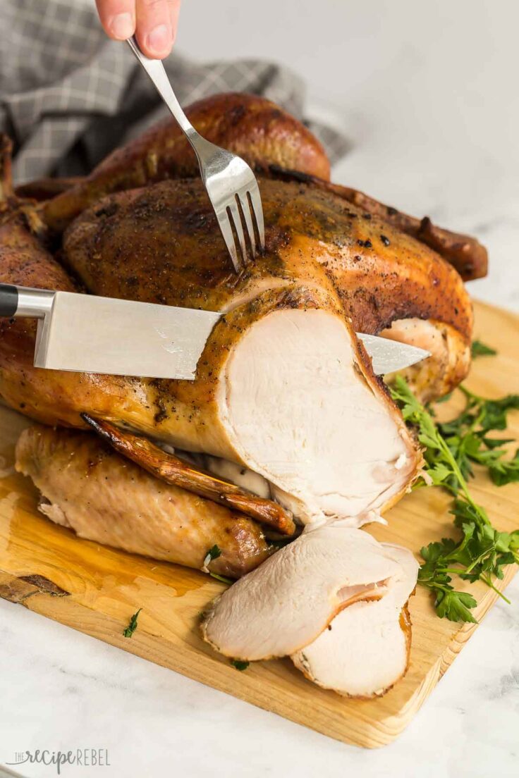 fork and knife being used to slice turkey breast from roast dry brine turkey