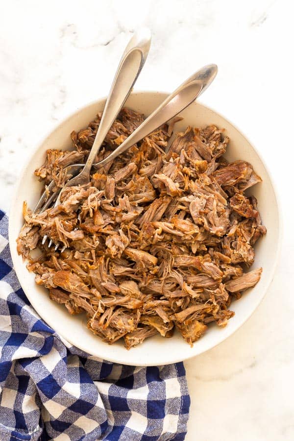 This Instant Pot Pulled Pork is made with SIX ingredients and is full of flavor! With garlic, brown sugar, apple juice and seasoned well, it is the perfect mix of sweet and savory, plus fall apart tender! #instantpot #pressurecooker #pork #pulledpork instant pot pulled pork in bowl