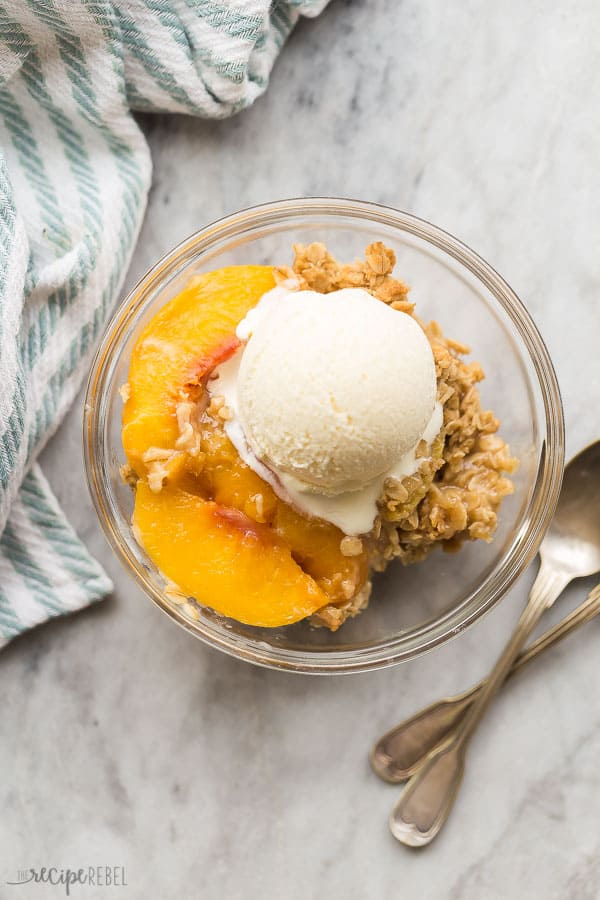 peach crisp with frozen peaches in bowl overhead on marble