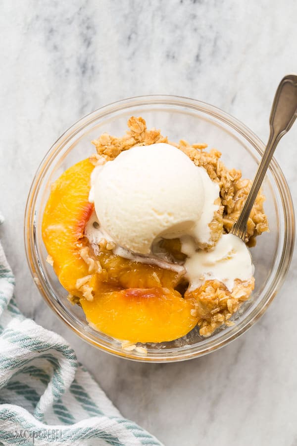 peach crisp in bowl overhead on marble background