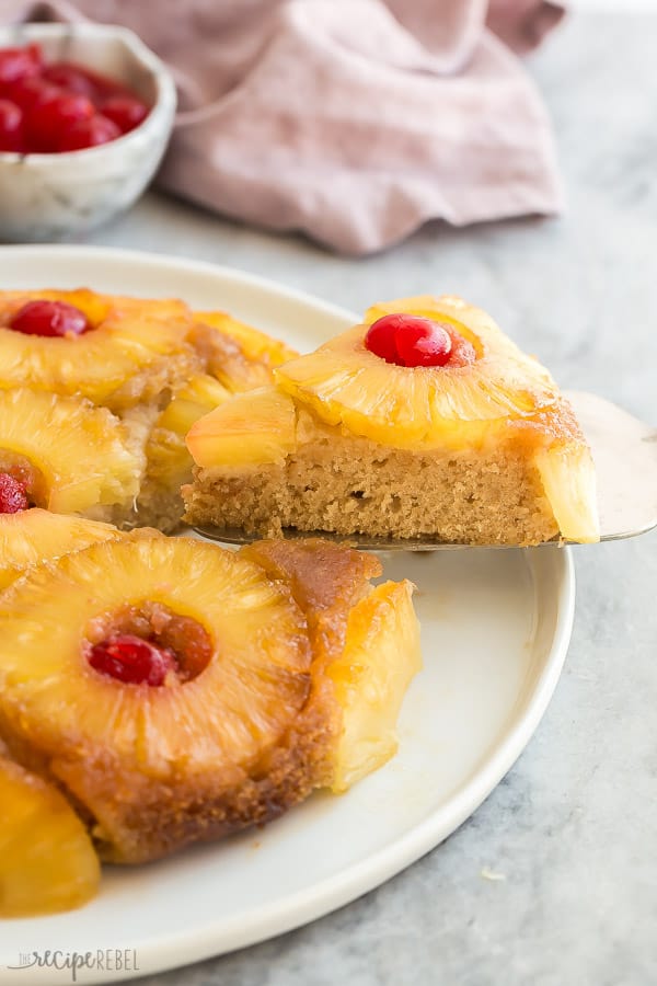 pineapple upside down cake slice coming out on serving utensil