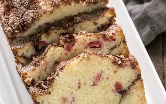 A loaf of sliced cinnamon rhubarb bread.