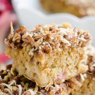 Three slices of rhubarb streusel coffee cake stacked on top of one another.