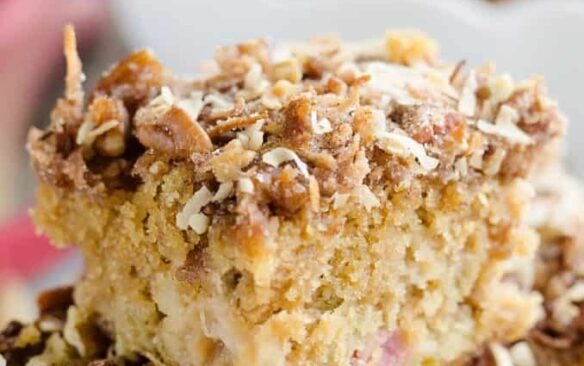 Three slices of rhubarb streusel coffee cake stacked on top of one another.