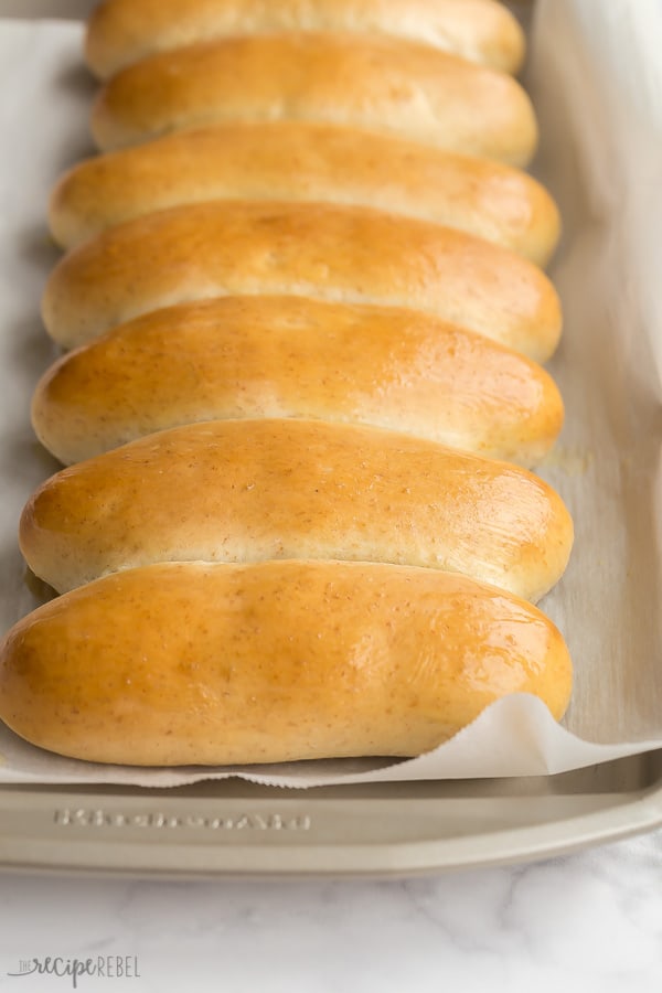 hot dog buns lined up on sheet pan