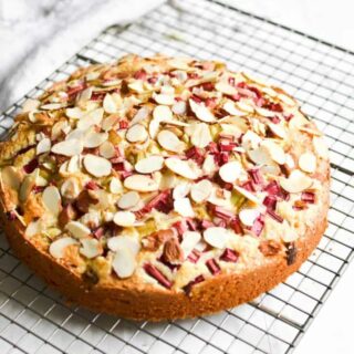 A whole rhubarb cake on a wire rack.