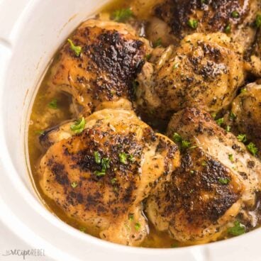 square image of bone in chicken thighs in slow cooker.