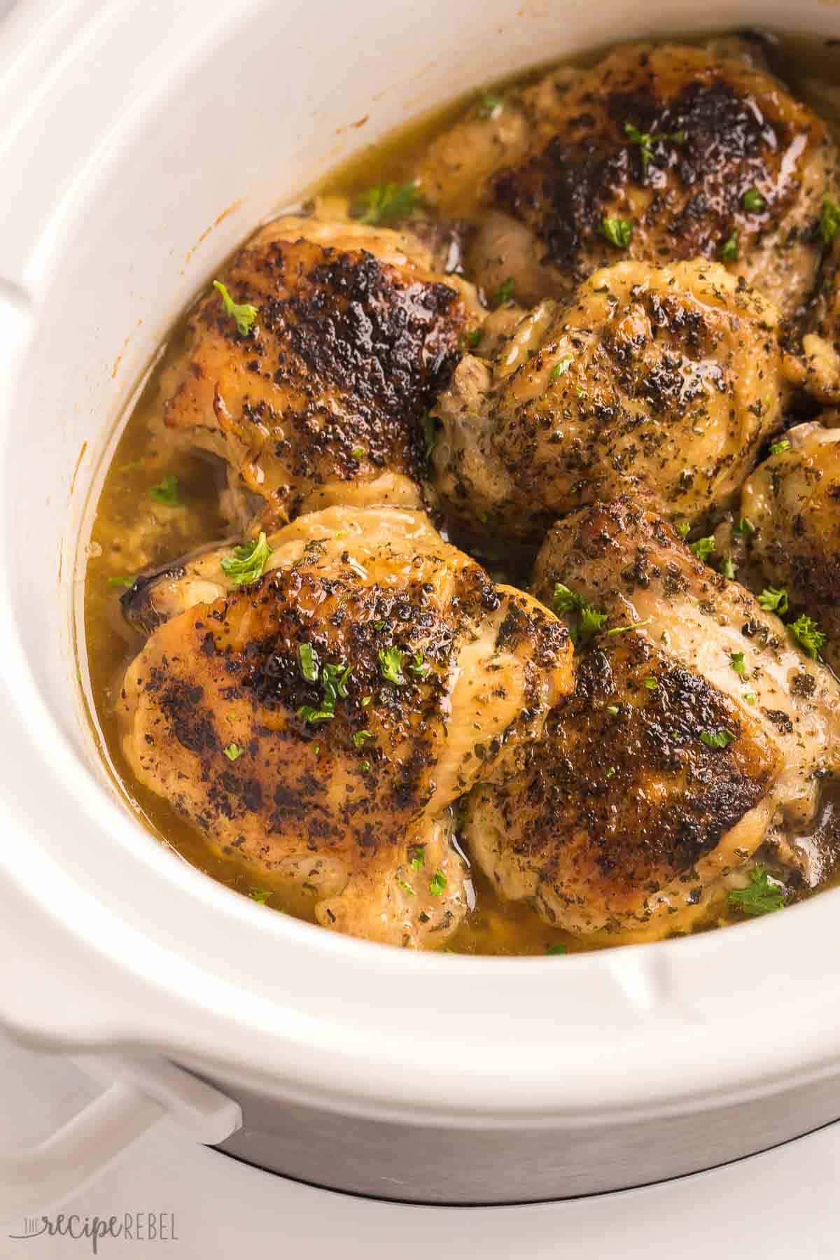 close up image of bone in chicken thighs in crockpot.