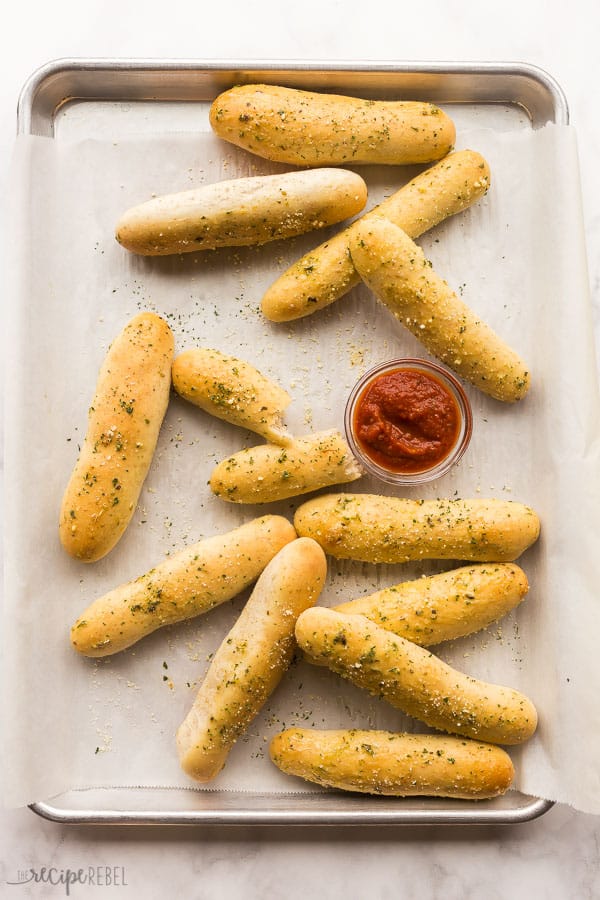 breadsticks overhead with tomato dipping sauce