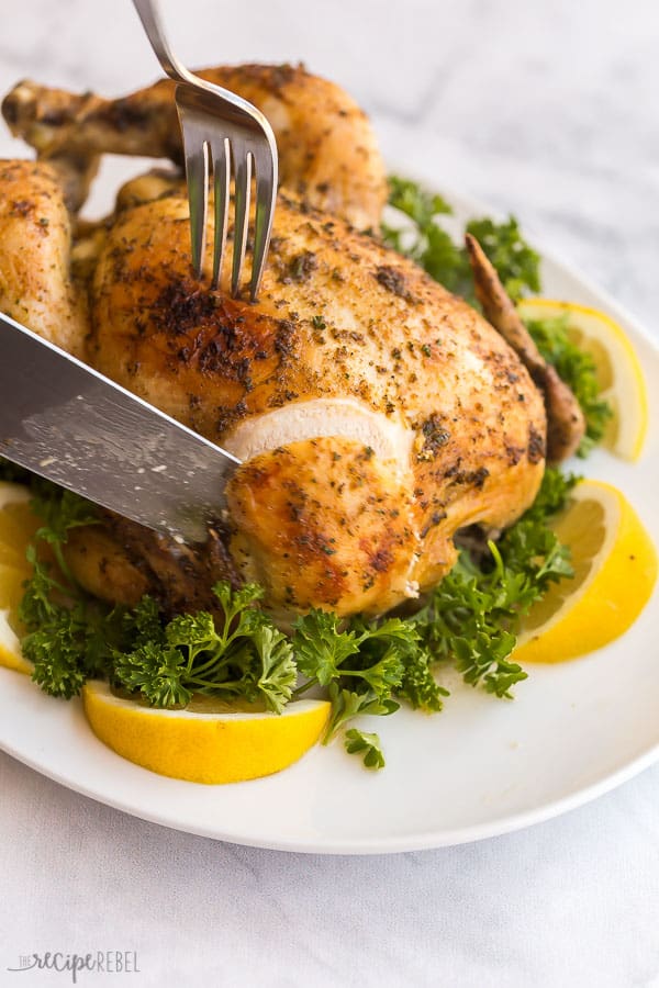 crockpot whole chicken sliced with parsley and lemon