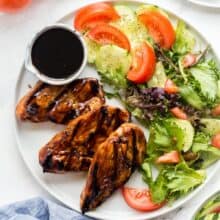 grilled chicken with marinade on white plate overhead