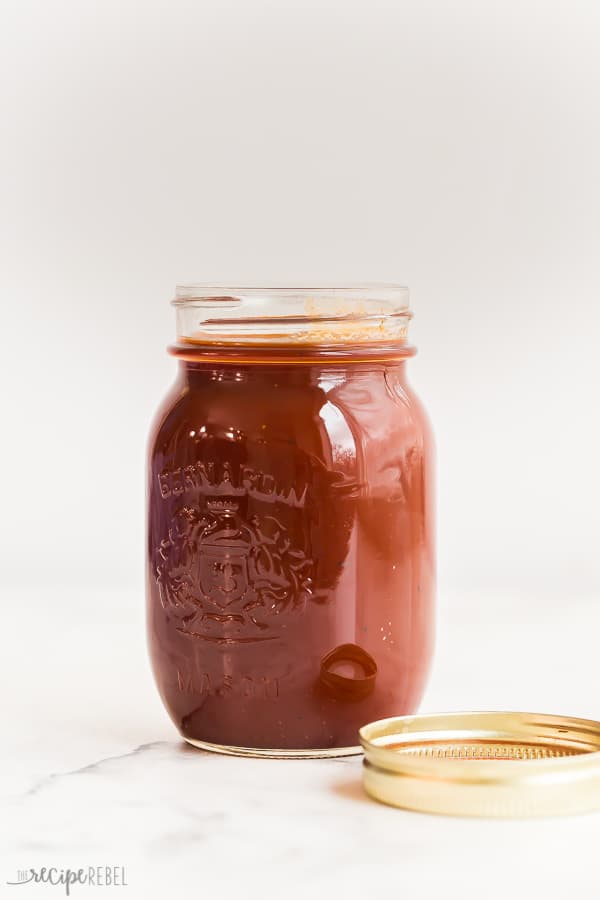 This Homemade BBQ Sauce is thick, sweet, smoky and a little spicy! It's big on flavor and pairs well with chicken, pork, beef or anything on your grill! Full step by step recipe video down in the recipe card. #bbq #barbecue #bbqsauce #grilling #recipe homemade bbq sauce in mason jar