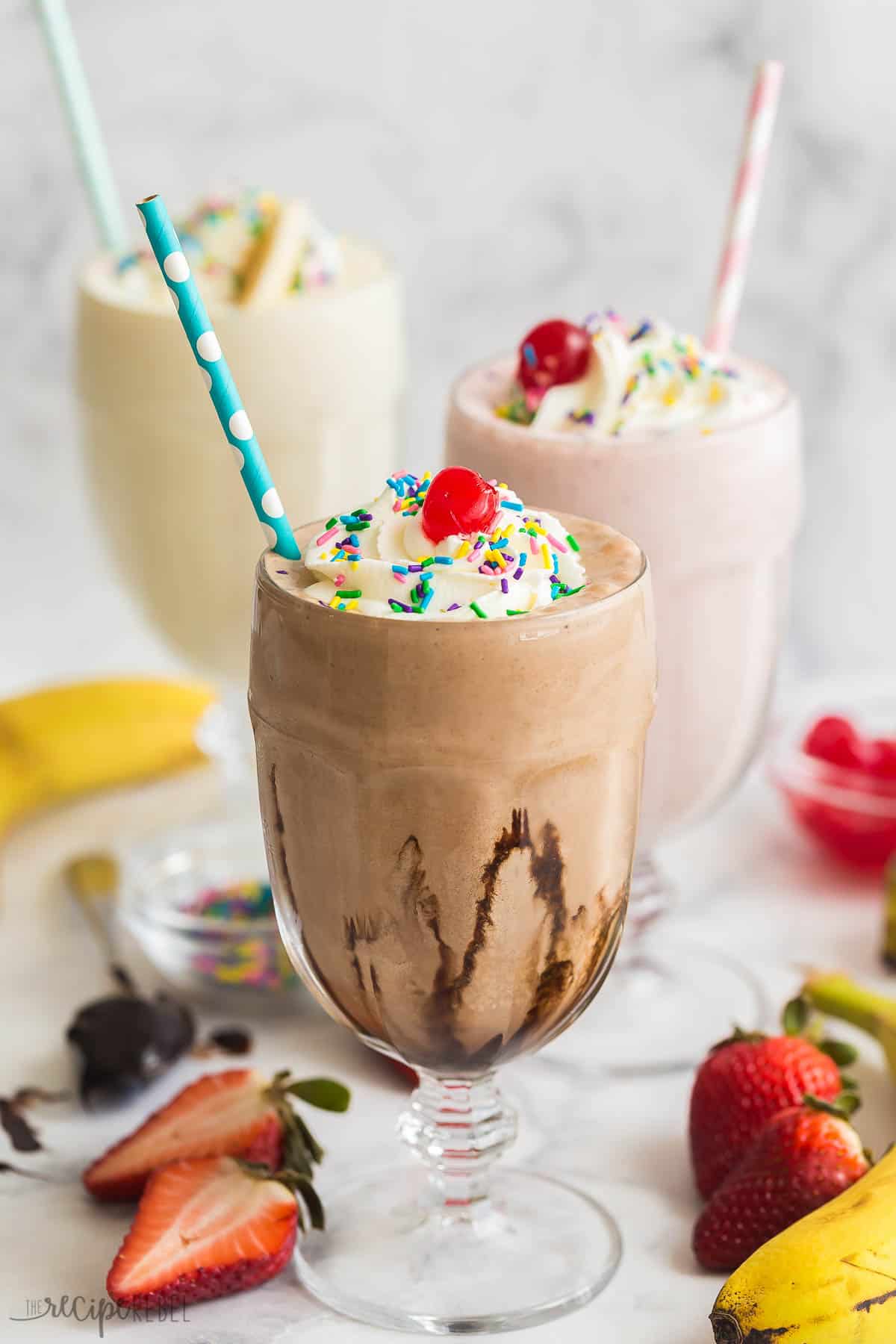 Today I'm showing you all my tips on How to Make a Milkshake! This post shows you just how easy it can be, with a simple milkshake recipe formula plus tons of variations, you'll be making a new version every day of the week. #milkshake #icecream #recipe | dessert recipes | ice cream recipes | ice cream ideas | ice cream dessert | summer dessert | summer drinks | cold drinks how to make a milkshake with three flavors in glasses with straws.