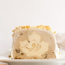 maple ice cream cake sliced on white plate with white background