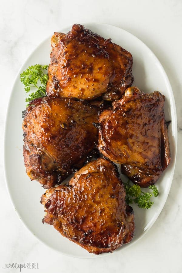 maple soy grilled turkey thighs overhead on white platter on marble background