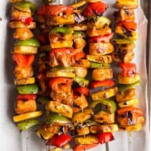 hawaiian chicken kabobs cooked with pineapples and peppers on sheet pan