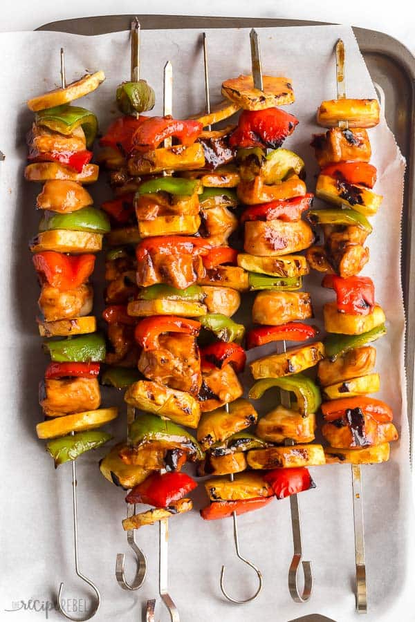 hawaiian chicken kabobs cooked with pineapples and peppers on sheet pan